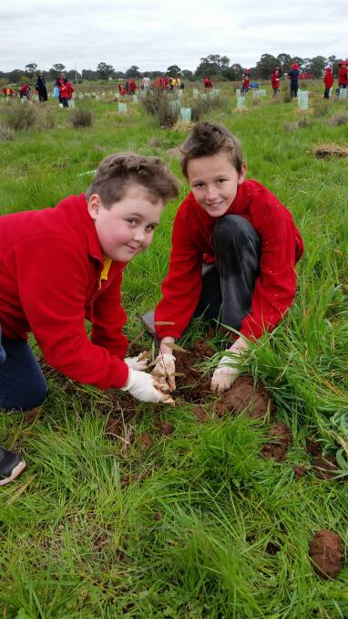 Digging the Fun: Preston Kennedy and Ethan Graham did last year during National Tree Day activities. Go to the treeday.planetark.org to register.
