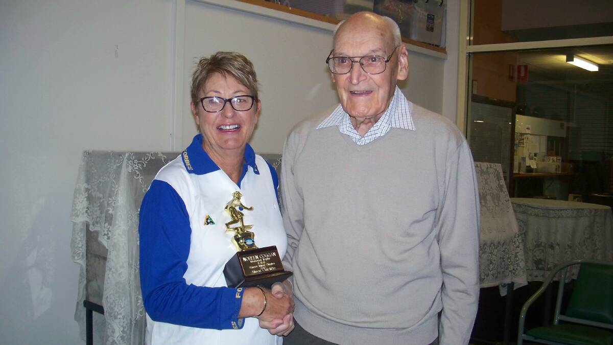 Congratulations: Alison Cutcliffe being presented with the Noreen Coggan Memorial trophy for winning the Minor Singles Club Competition by Harry Coggan. 