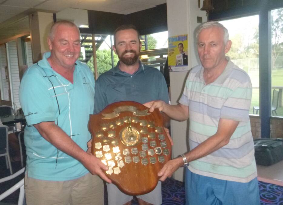 Twin Towns Shield: Parkes GC Captain Peter Dixon (left) presents the Twin Towns Shield to Forbes Club captain Steve Grallelis (right), with assistance from Club Pro and organiser Simon Houston.