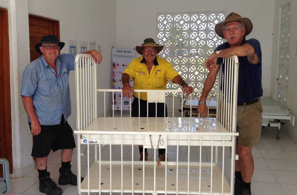 Clinic staff were very excited to have new medical equipment delivered from Australia. Doug Hawken, Roger Hood, and Bill Shallvey had some difficulty maneuvering this cot through the doorways.    