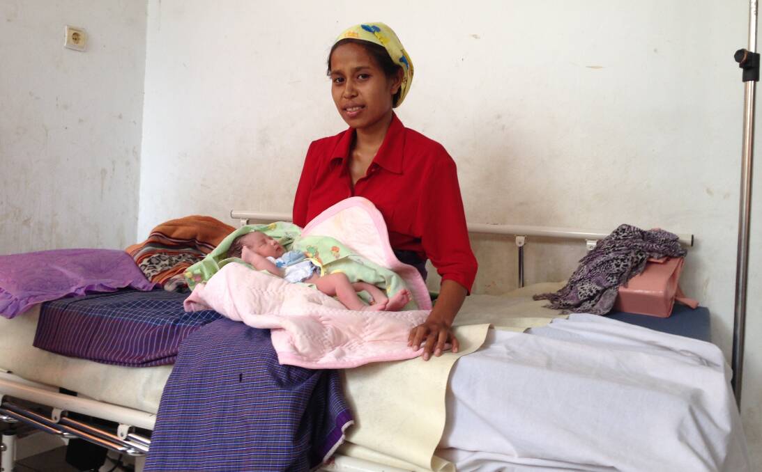 The shipping container filled with surplus medical equipment from the old Parkes and Forbes Hospitals has been delivered to East Timor. Martina de Jesus, who had just given birth, is sitting on a donated bed and mattress.   