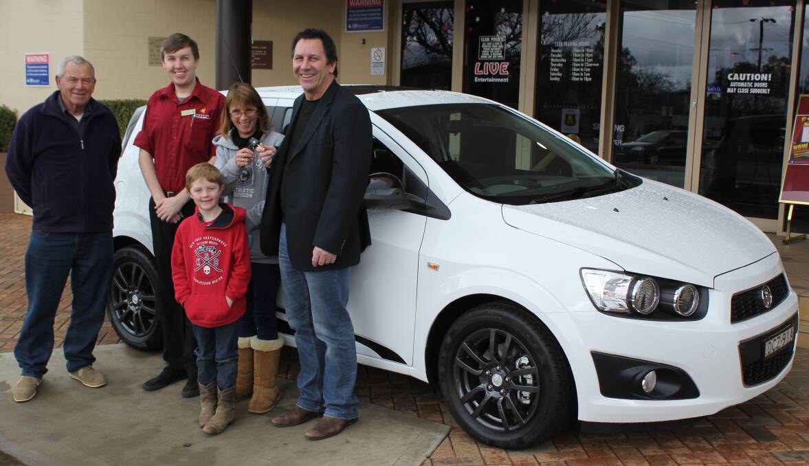 Forbes Services Memorial Club's general manager David Fitzgerald hands over the keys of the Holden Barina X to lucky winner Lisa White, who will share the car with her uncle, Don White (left). They are pictured with Lisa's grandson Jack Coleman (front) and the face of the promotion Patrick Hodges.