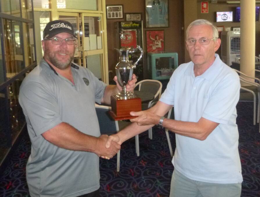 Andrew Dukes receiving the AAA Cup from Steve Grallelis.