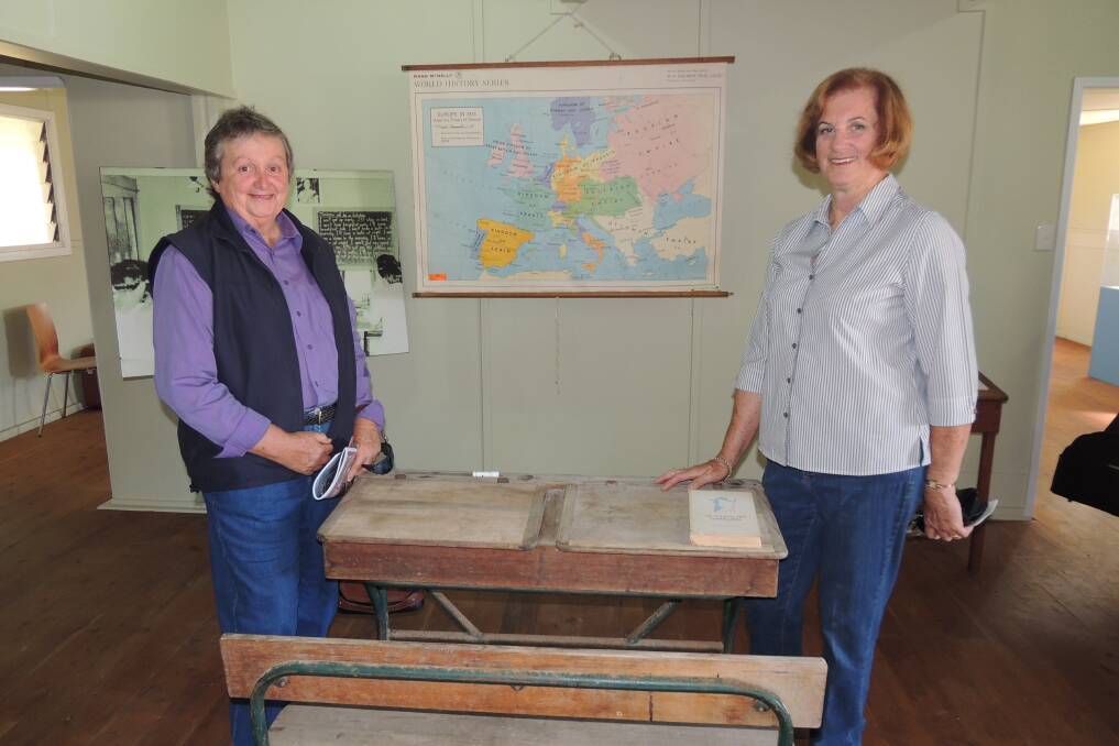 Ruth Armstrong and Helen Pitt reminiscing about school days at the Bonegilla Migrant Village. Photo contributed. 