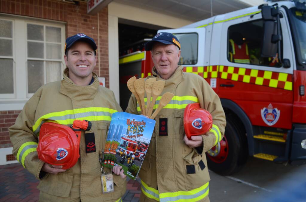 Local firies Mat Teale and Brian Clarke invite Forbes families to visit the station on Saturday.