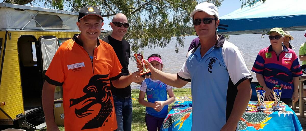 Colin of Colour City Dragons and Neil Stevens of Lachlan Dragons accepting the trophy for second in the men's event at the Wagga Wagga regatta.