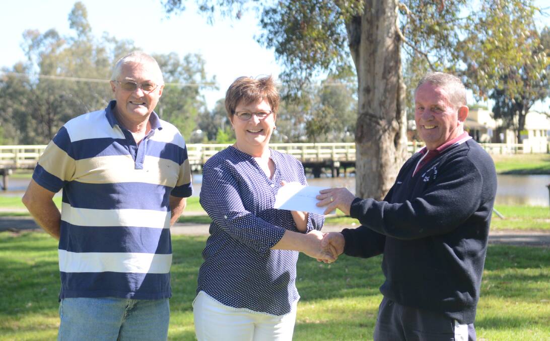 A delighted lunch organiser Debbie Roylance receives a cheque from John Schrader and Peter Corliss. 