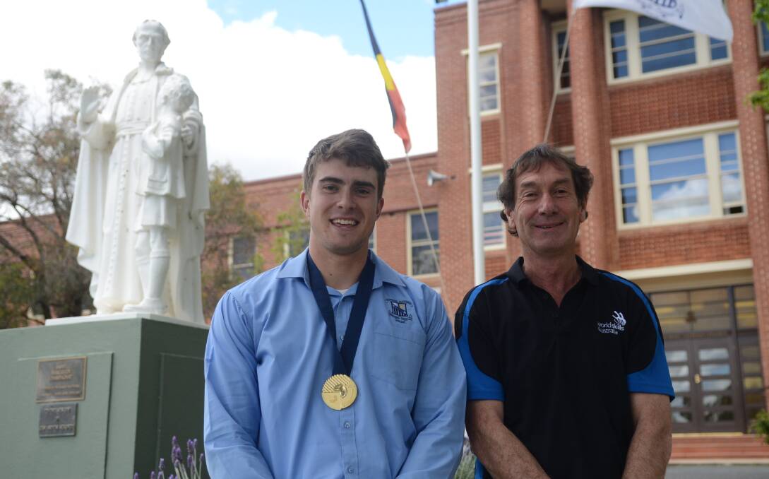 College student Sam Carty, wearing his gold medal, with proud agriculture faculty coordinator Col Hawthorn.