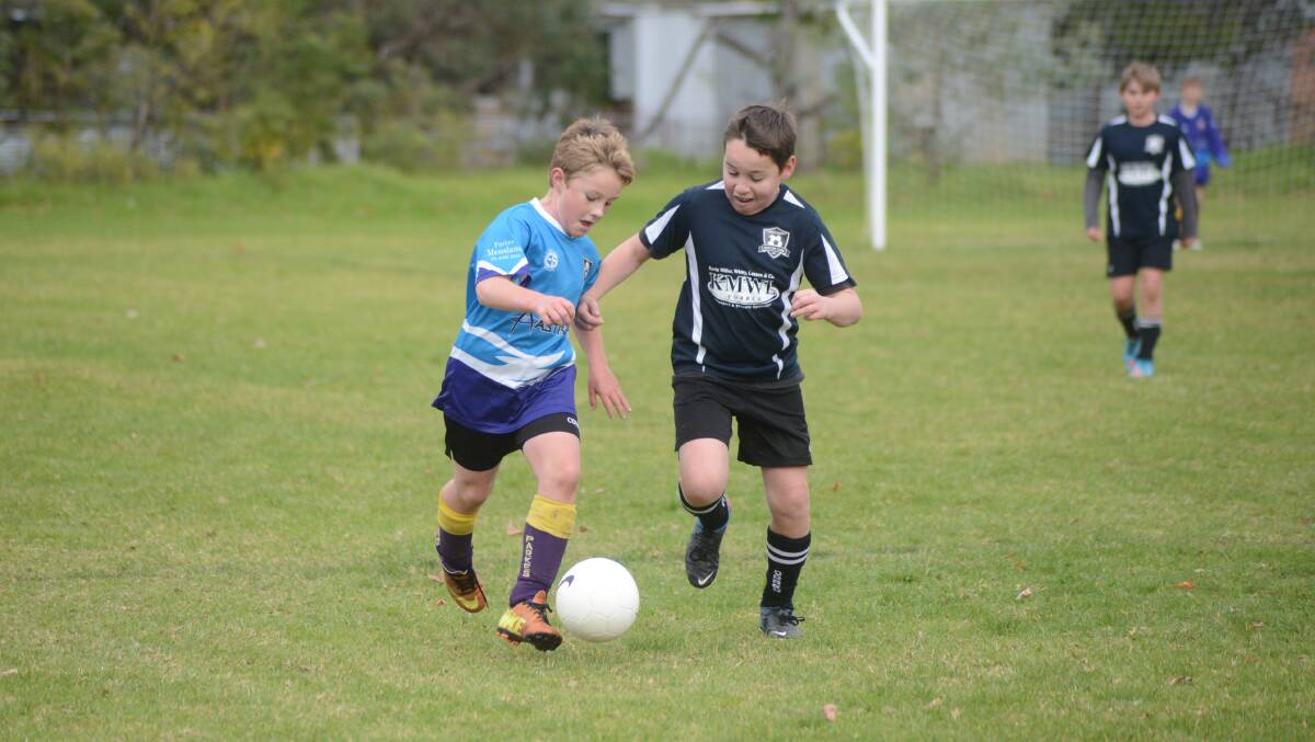 Parkes' Joel Macgregor and Forbes' Dylan Jones go for the ball in a junior soccer gala day in Forbes last year.