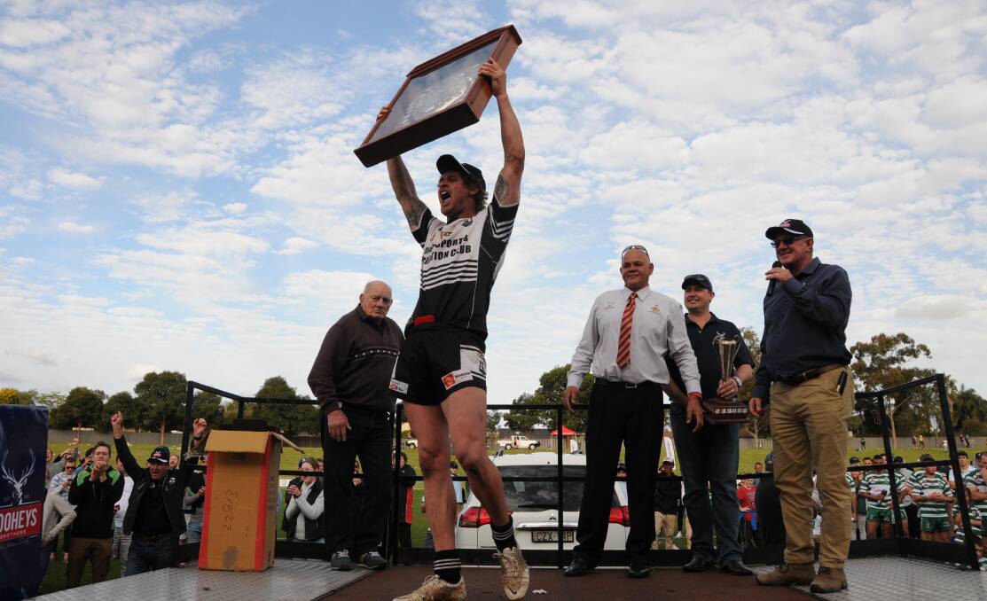 DROUGHT BROKEN: Jake Grace lifts the premiership shield aloft at Caltex Park. Photo: BELINDA SOOLE