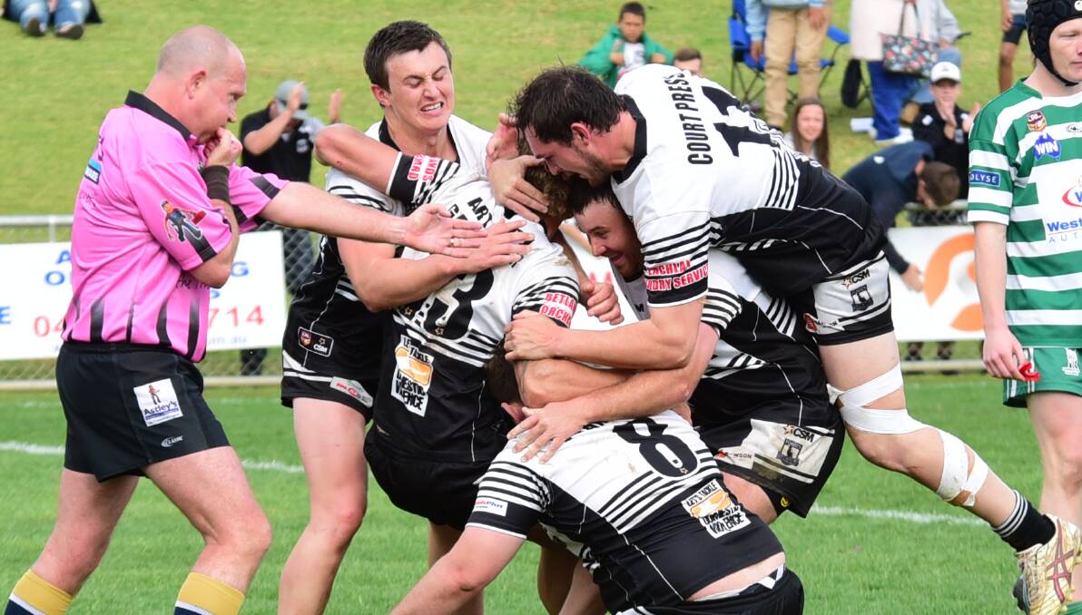 MOBBED: Jake Grace (No.13) is mobbed after scoring a try in the grand final at Caltex Park against CYMS. Photo: BELINDA SOOLE
