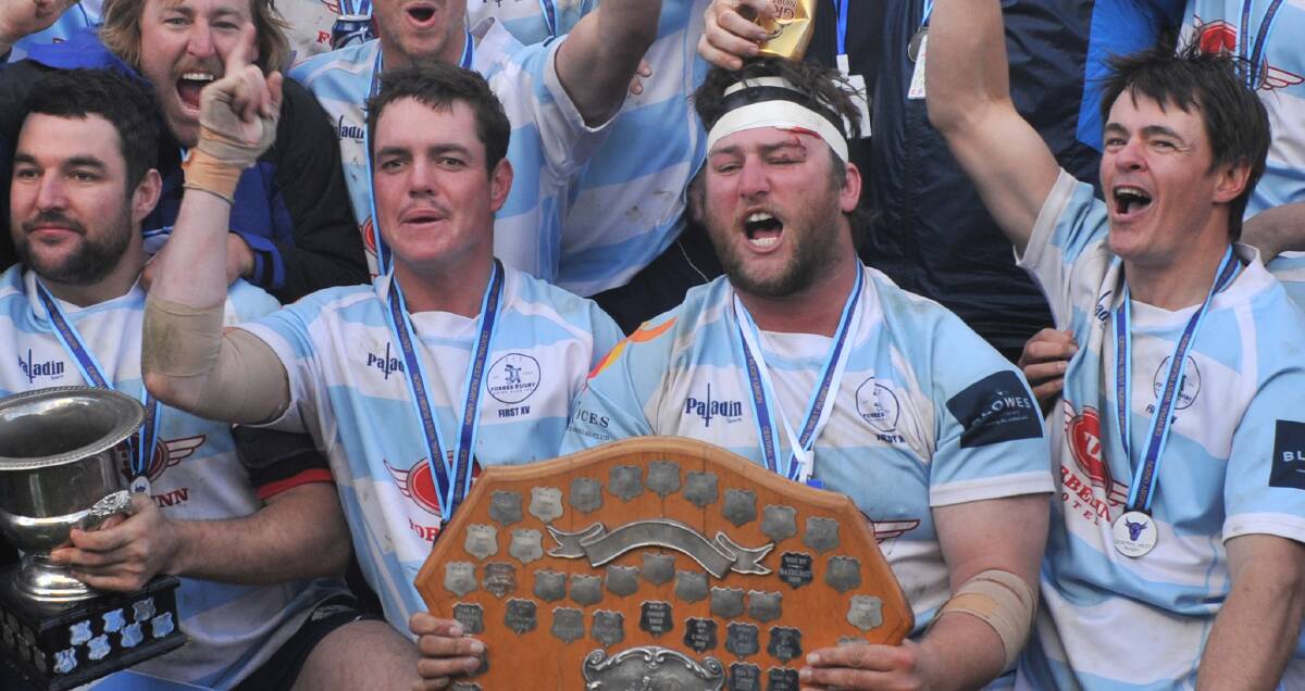 ALL SMILES: Jarrod Hall and Jack Hammond hold the Blowes Clothing Cup shield after Saturday's win. Photo: JUDE KEOGH