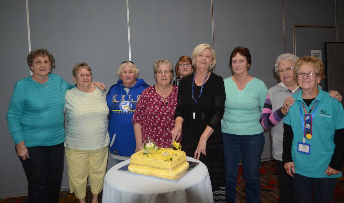 Sunshine Club volunteers celebrate the milestone with a 78th birthday cake created and decorated by Irene Ford.