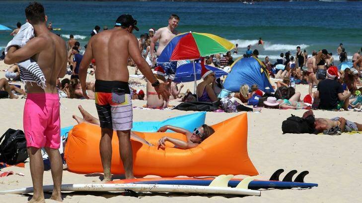 Another country: People celebrate Christmas Day on Bondi Beach. Photo: Ben Rushton
