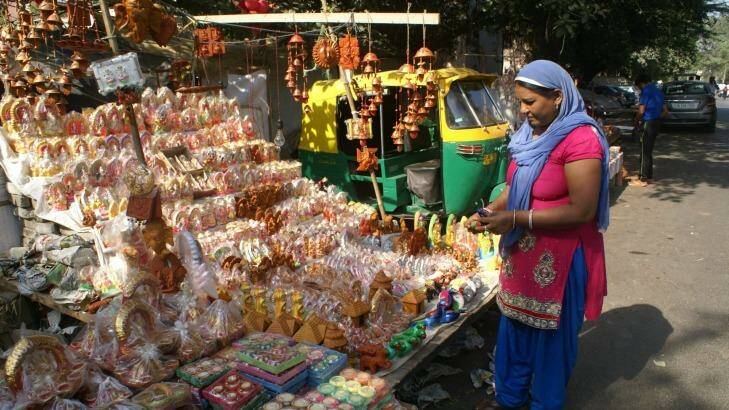 A woman shops for clay Hindu figurines in preparation for Diwali. Photo: Amrit Dhillon