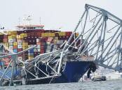 "The best minds in the world" are working to clear bridge debris and move the cargo ship. (AP PHOTO)