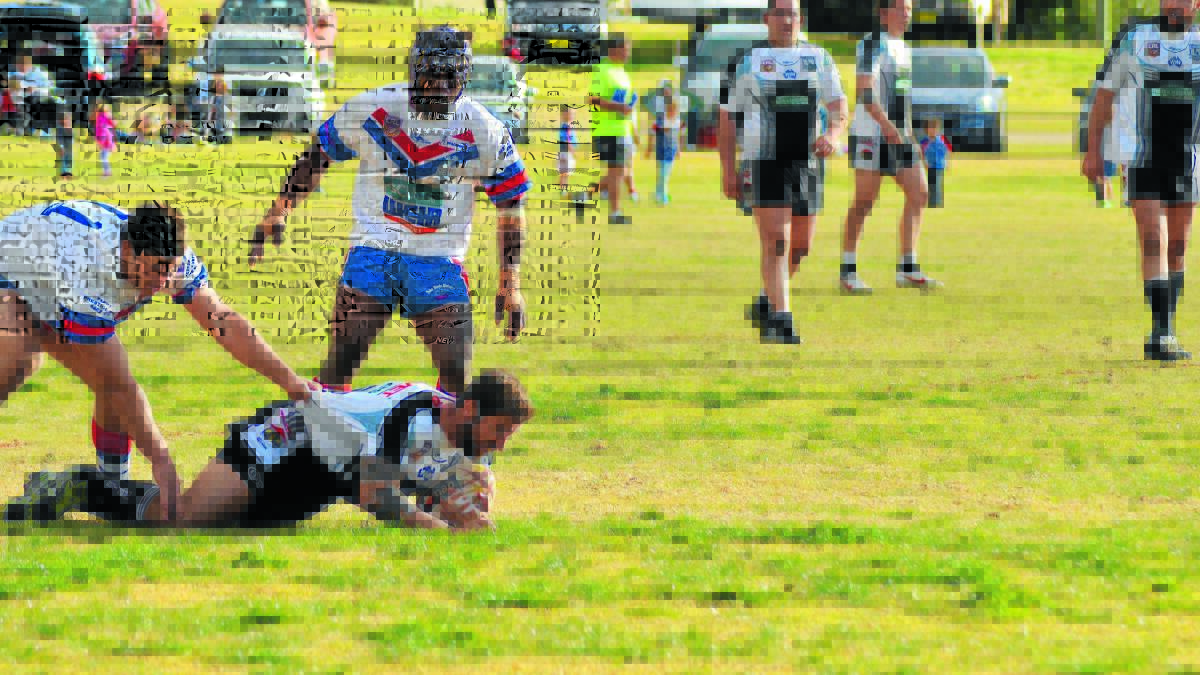 Forbes Magpies player Pat Rudd is tackled by Parkes Spacemen Jordan Pope (left) and Epi Sadrodro. Parkes will meet Nyngan in the first week of the Group 11 finals, regardless of results this weekend. 0814magpies10 (1)
