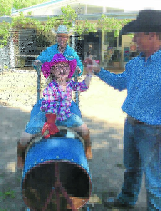 Organisers of the Forbes Rodeo Shaun and Troy Read took their makeshift bull to Forbes 
Preschool, where Beth Cannon enjoyed the ride, preschoolrodeo21