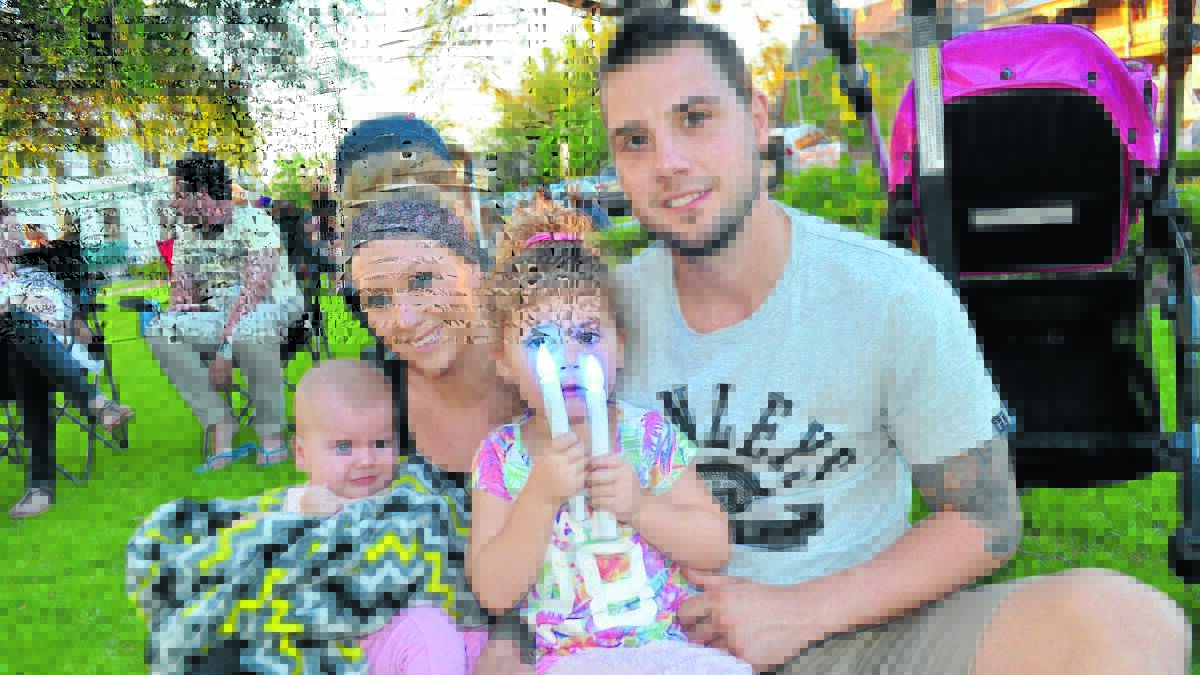 Enjoying a family night at Carols by Candlelight last year were Lauren and Shane Percy with their daughters Ebony and Ava. 