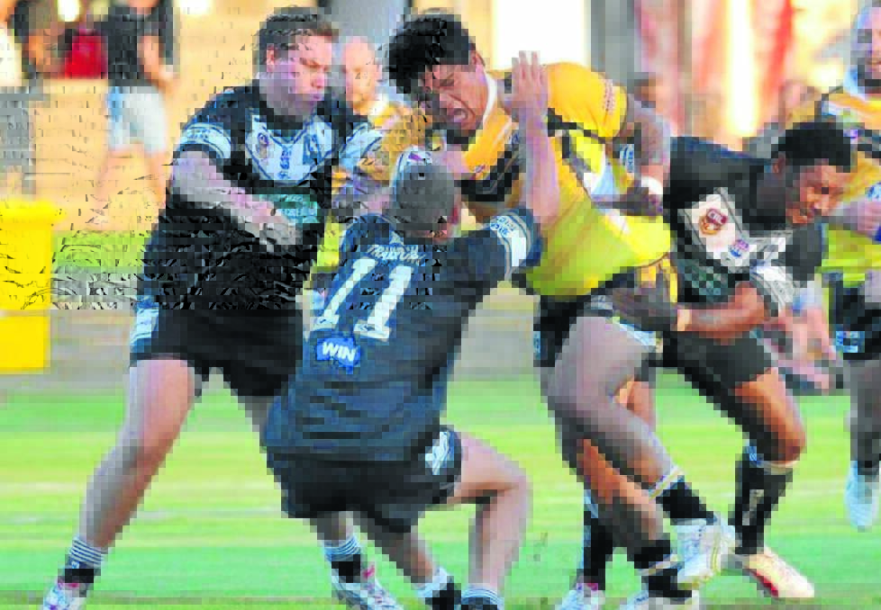Magpies Brad Herbert, Jake Grace and Seru Eremasi tackle Gundagai’s Vince Brown at the West Wyalong Knockout. Picture: Laura Hardwick, Daily Advertiser