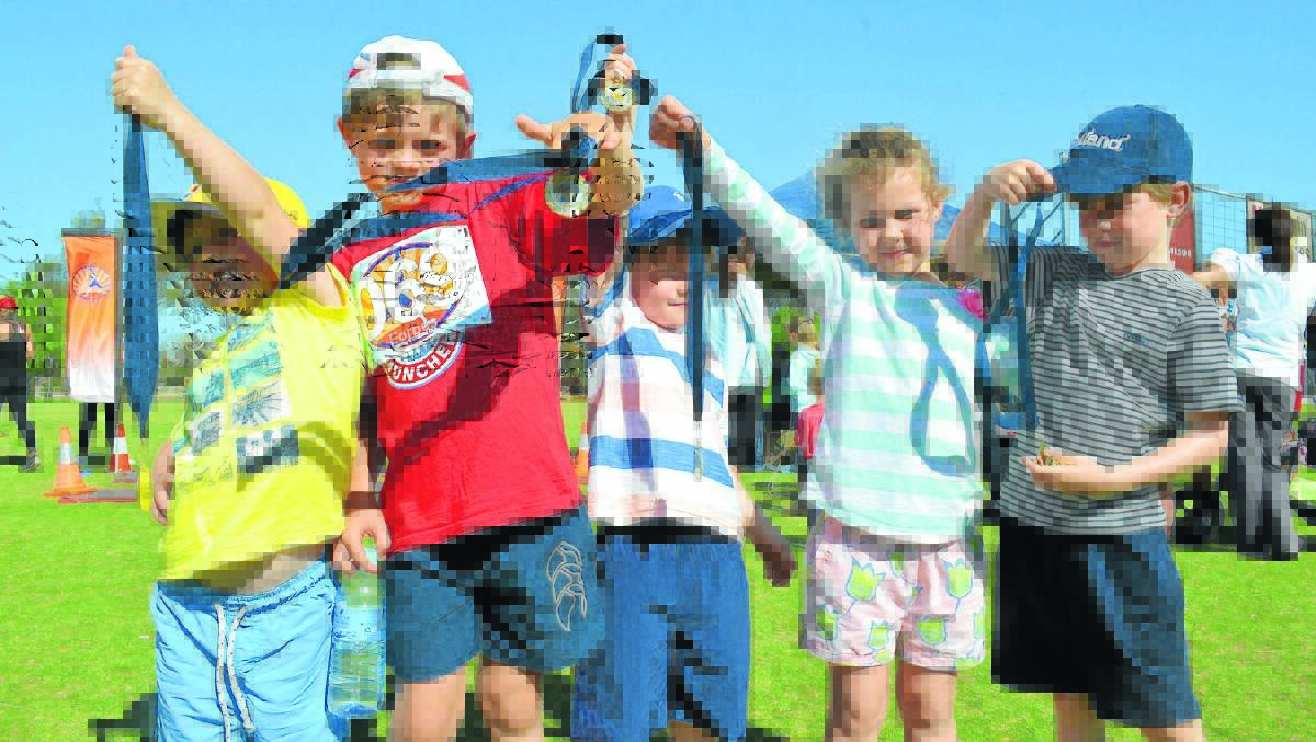 Kids held their medals high after last year’s running festival. Register now for Sunday’s event.