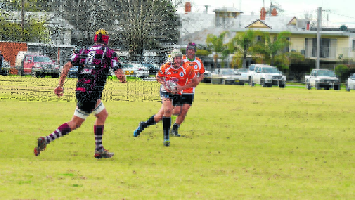 Daryen Hazell makes a run with the ball, flanked by brother Bryce Hazell during Saturday’s clash with the Parkes Boars. 0715platypiboars(62)