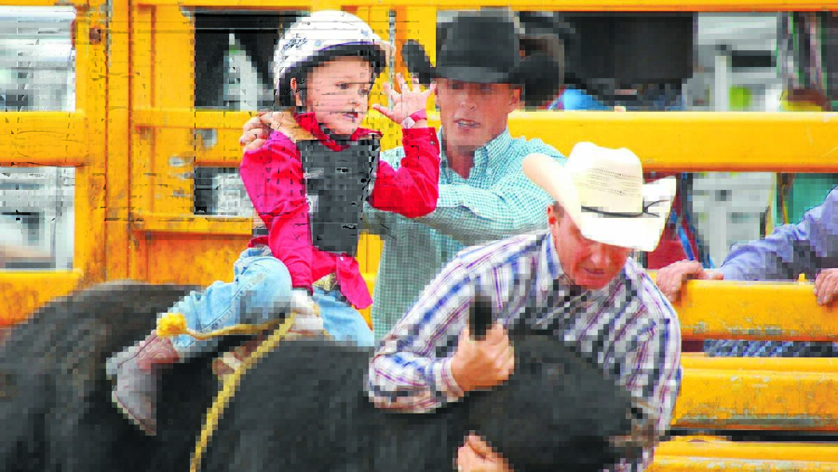 Coby Read, at the time aged four, competes in the Braidwood Rodeo two years ago, with the help of his uncle Troy Read and father Shaun Read. Photograph courtesy of JenSol Photography.