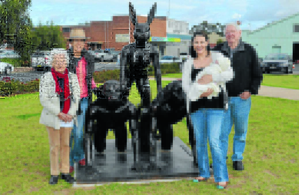 Goldie Ridley, Rosie Johnston, Jacqui Greig with baby Georgia Greig and WA tourist Frank Trager with the Pyramid sculpture, which will soon be leaving Forbes unless Forbes Art Society can find $20,000 to keep it.