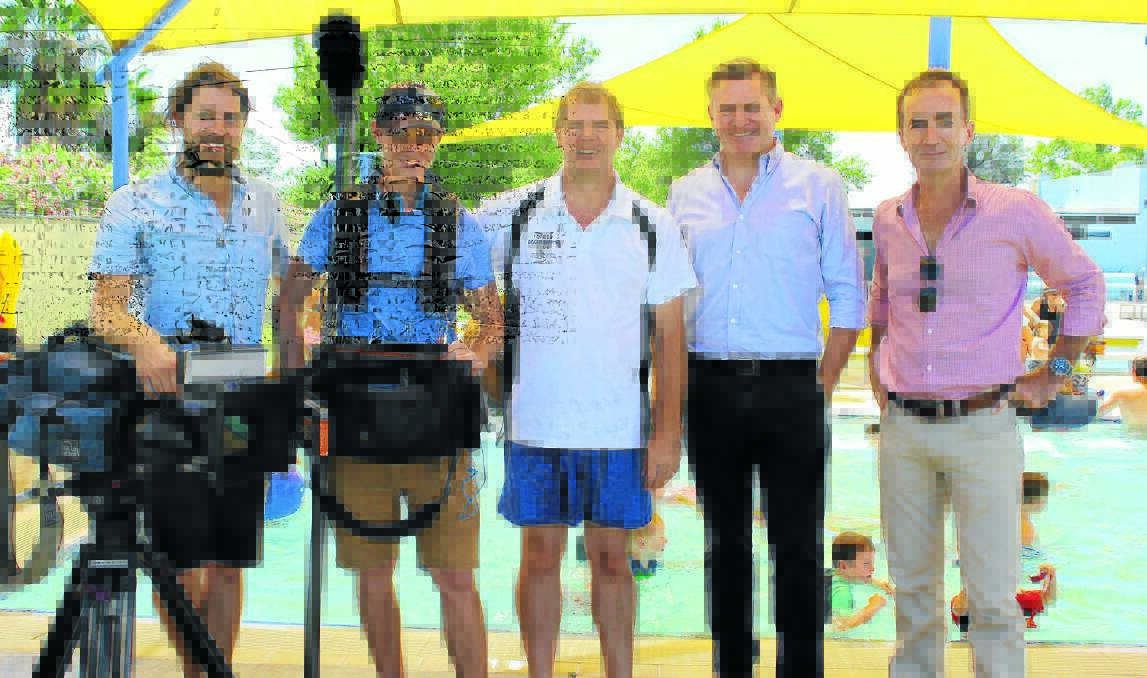 Andrew Drane (centre) with the crew from 60 Minutes; cameraman Dan Soekor, sound recordist Will Brincat, reporter Michael Usher and producer Stephen Taylor filming at the Tom Drane Memorial Swim.