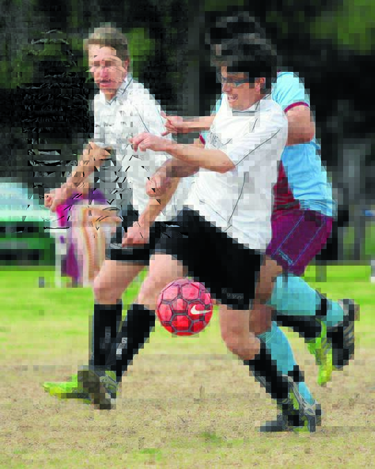 Gunns players Michael Sheather (with ball) and Luke Gleeson in action against Tichborne Tigers last weekend. Gunns won 3-0. Picture courtesy of Brian Scott.