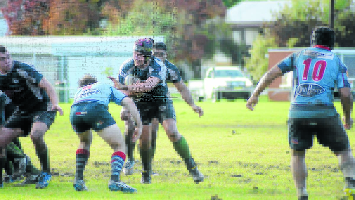 Bryce Hazell fends off the opposition in the muddy match against the Dubbo Kangaroos two weeks ago.