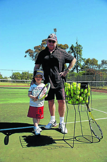 Tennis coach John Christopher at Nelson Park with five-year-old student Ethan Ray. Ethan has been attending lessons for about 12 months and is improving his game. 1014tennishcoach(1)