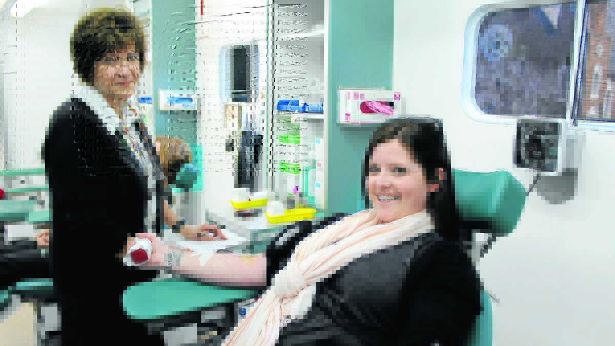 Registered nurse Kez McCarthy attends to the Advocate’s Melissa Coombs as she gives blood. 0814melissa(1)