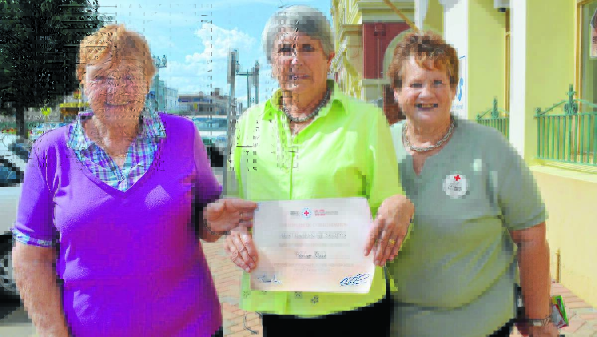 Red Cross volunteers Wilma Hepburn, Jean Hodges and Barbara Hoswell hold a certificate of achievement, which recognises 100 years of the organisation’s operation in Forbes. 0315redcross(1)