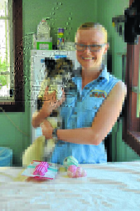 Forbes Veterinary Clinic vet Saraih Werry with Remy, who suffers from anxiety issues, and some of the Kong dog toys available at the clinic. 0214politepets2