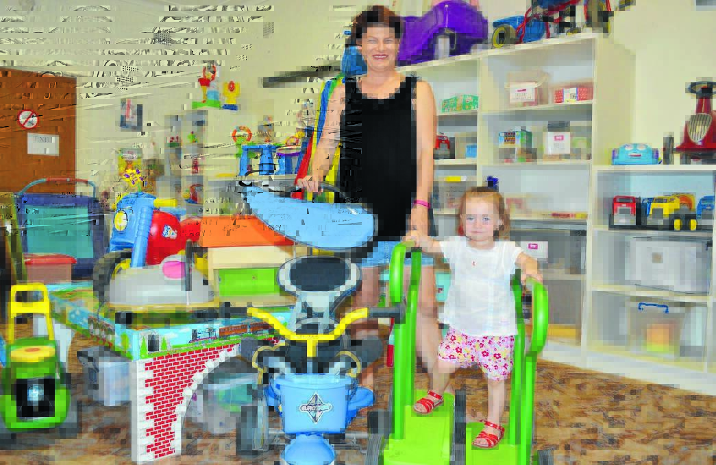 Nikki Patten and daughter Indrie O’Connell with the large selection of toys on offer at the Forbes Toy Library, including new items. Money raised at the Melbourne Cup Luncheon will go towards purchasing more toys. 1014toylibrary
