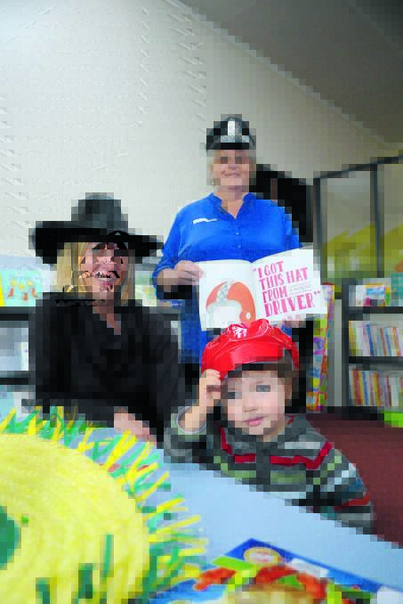 Harvey (2) and mum Kerrie Bruem with library assistant Sharon Barber who read “I got this hat” at Forbes library, along with readers all over Australia. 