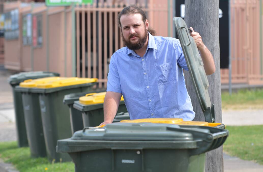 BIN THERE: Bathurst man Harry Chamberlain takes out the rubbish yesterday. 021915zharry