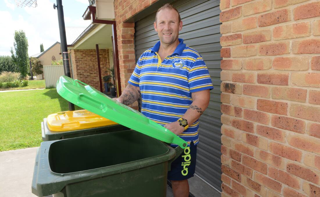 HAPPY CUSTOMER: Some residents refuse to use their newly delivered green bins, but Llanarth resident Peter Bowker couldn’t wait for his to arrive. Photo: PHILL MURRAY 	030916ppeter