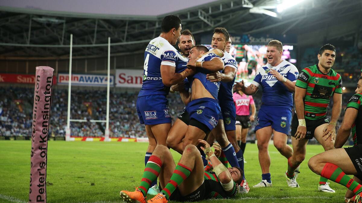 Corey Thompson of the Bulldogs celebrates with team mates after scoring a try during the round seven NRL match between the South Sydney Rabbitohs and the Canterbury-Bankstown Bulldogs at ANZ Stadium on April 18, 2014 in Sydney, Australia. Photo: Mark Metcalfe/Getty Images.