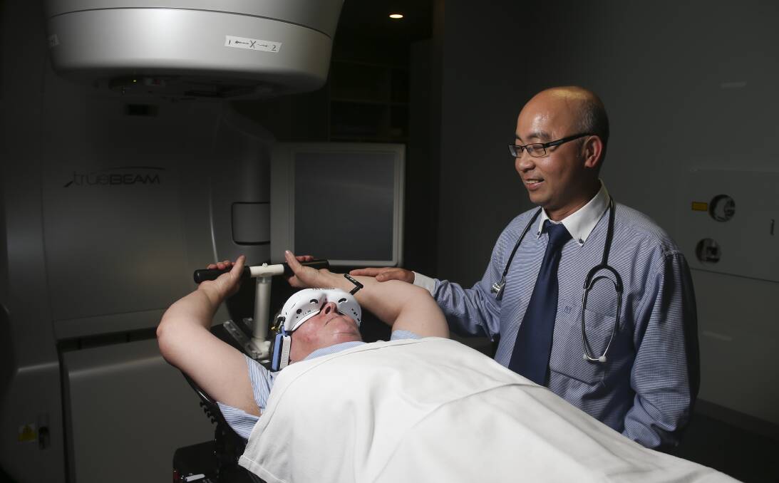 PIONEERS: Veronica Buckley demonstrates Deep Inspiration Breath Hold, as Murray Valley Radiation Oncology Centre's Eddy Ong looks on. Miss Buckley is the centre's first patient to use this technique. Picture: ELENOR TEDENBORG