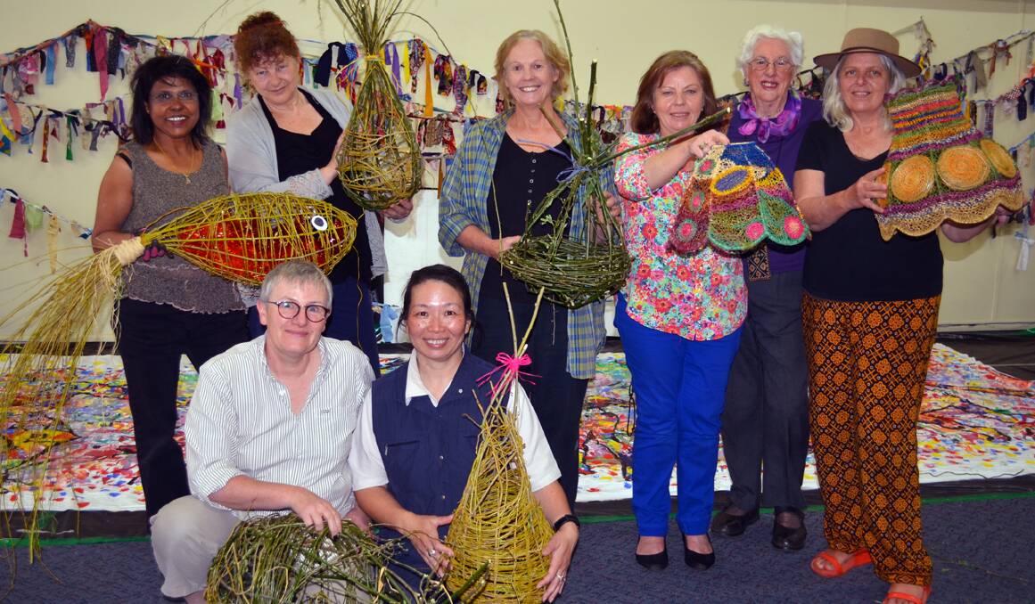(Back) Hawa Wright, Melody Ruhrmund, Jane Bennie, Helen Worsley, Dorothy Findlay and Merrill Findlay, (front) Margot Jolly and Lanny Mackenzie with some of the lanterns they created in the lantern weaving workshop for the River Arts Festival. 1013lanternweaving