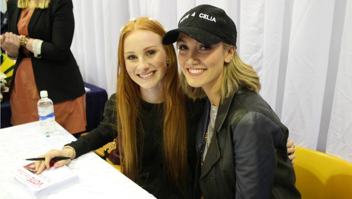 Celia Pavey and Delta Goodrem signing autographs. Photo: Stacey Miller