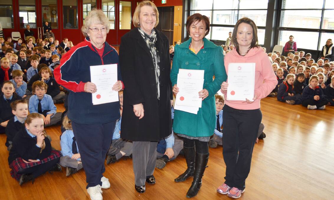 St Laurence’s Parish School principal Prue Horan (second from left) with award winners Jan Bradley, Leonie Burton and Lisa Griffiths at the school assembly on Friday.