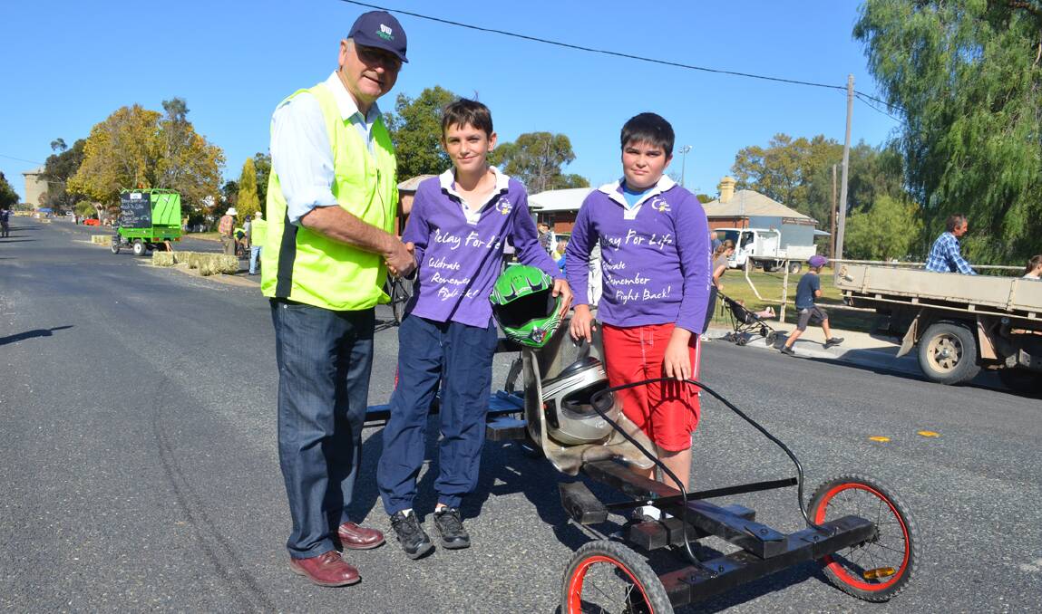Forbes Mayor Ron Penny congratulates Nicholas Toole and Jacob Smith, winners of the under 12 section in last Sunday’s Rotary Billycart Challenge, the first event of the Heritage Week program.