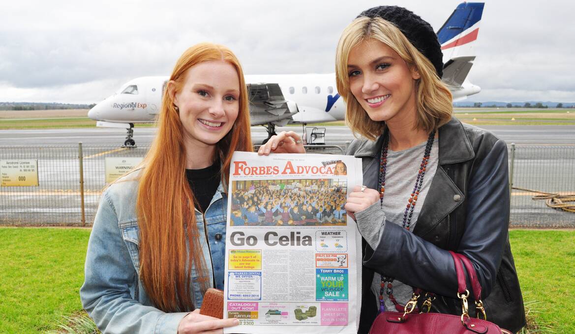 Celia Pavey and Delta Goodrem with a copy of the Forbes Advocate, which has been right behind Celia's quest to win The Voice.