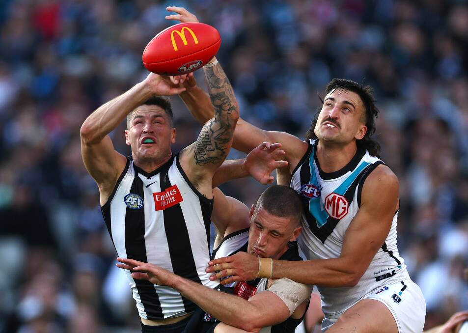 Jack Crisp, of the Magpies, marks in front of Port Adelaide's Ivan Soldo during their MCG clash on Saturday. Picture by Quinn Rooney/Getty Images