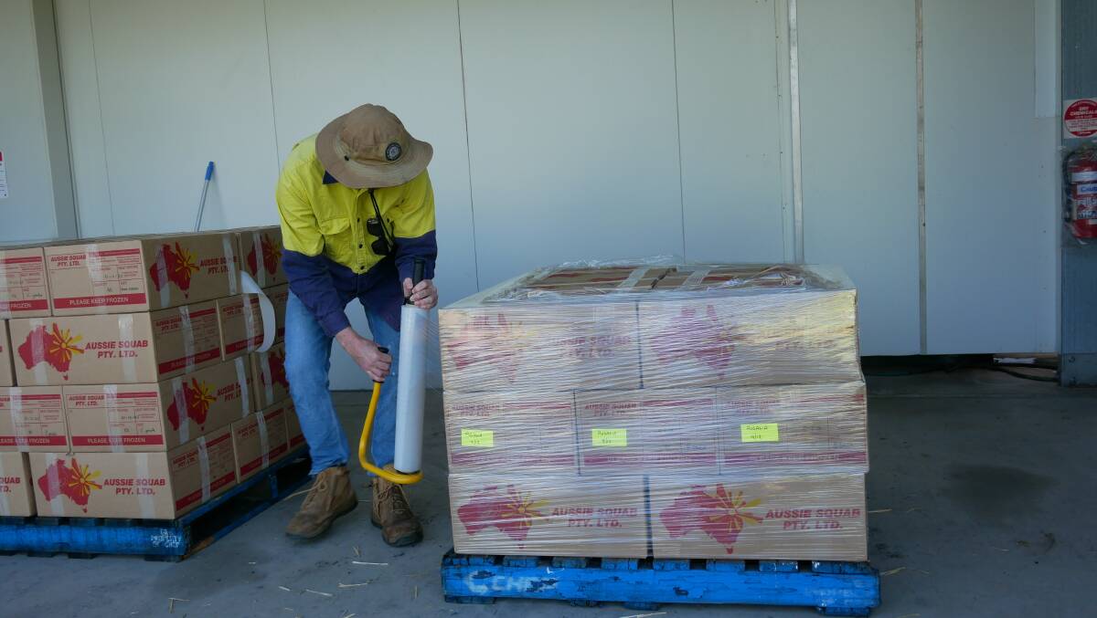 An Aussie Squab employee wraps pallets heading to Brisbane and Sydney later that day. 