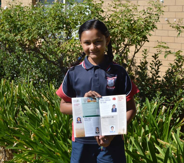 Hiya Changela holding the commemerative Anzac Day booklet which her winning poem is published in. Photo by Madeline Blackstock