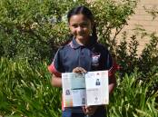 Hiya Changela holding the commemerative Anzac Day booklet which her winning poem is published in. Photo by Madeline Blackstock
